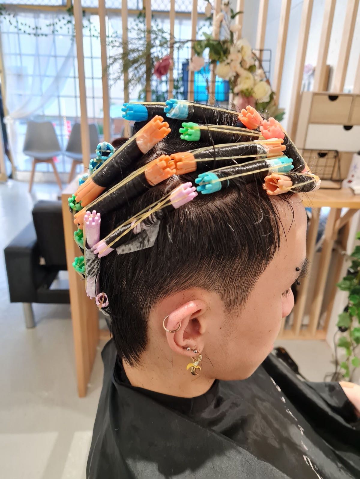 Men's perm in progress with perm rods